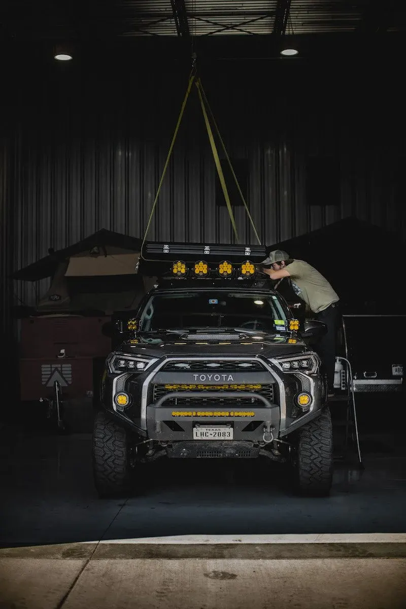 Toyota 4Runner with roof lights inside a dark garage