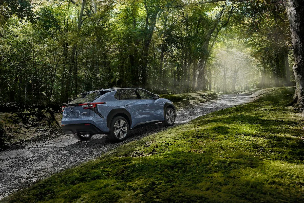 Subaru Solterra electric suv on a trail surrounded by trees