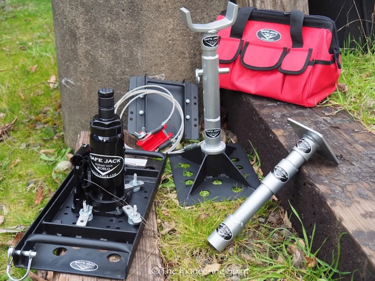 Safe Jack jack kit with base plate and extension laid out on grass