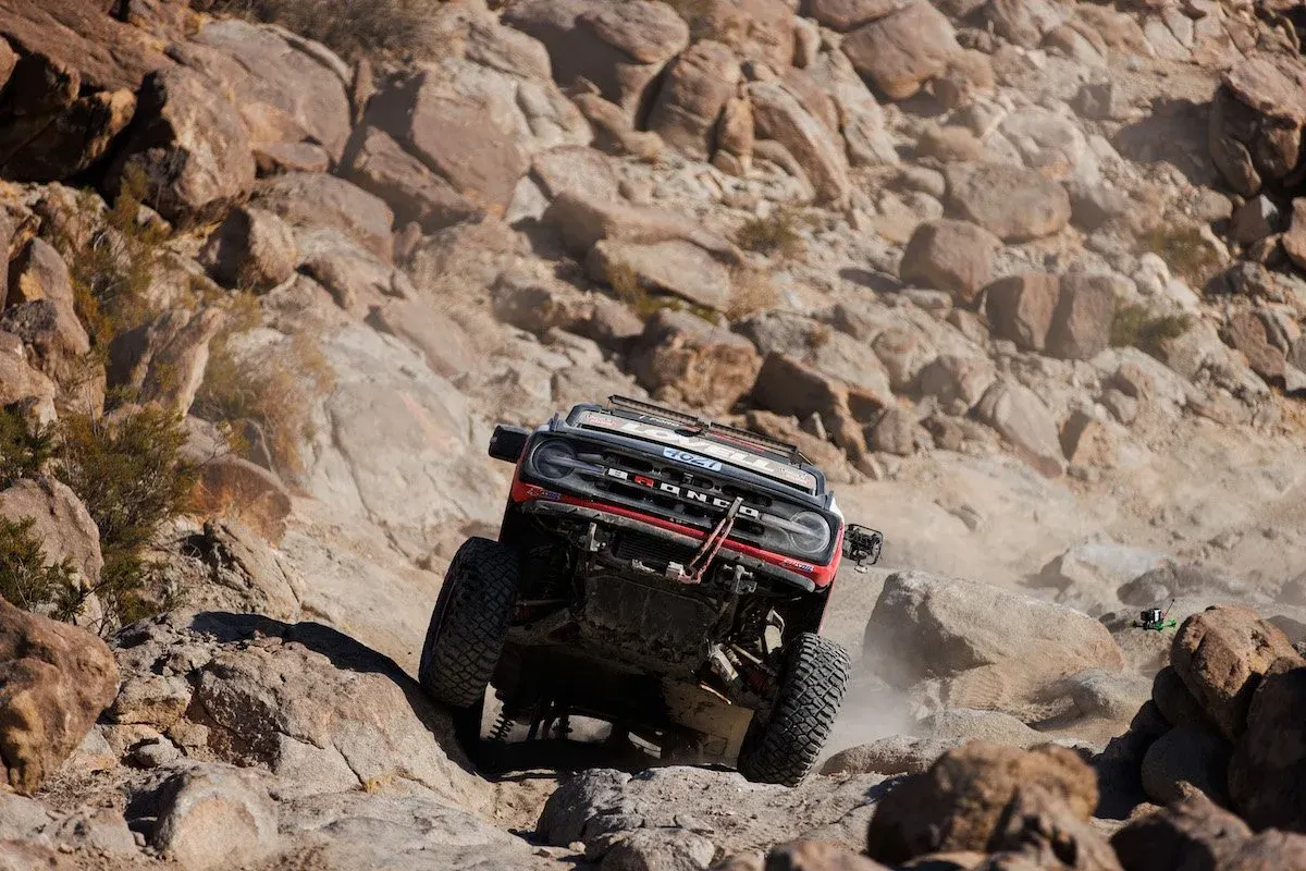 Ford Bronco race truck descending a rocky trail