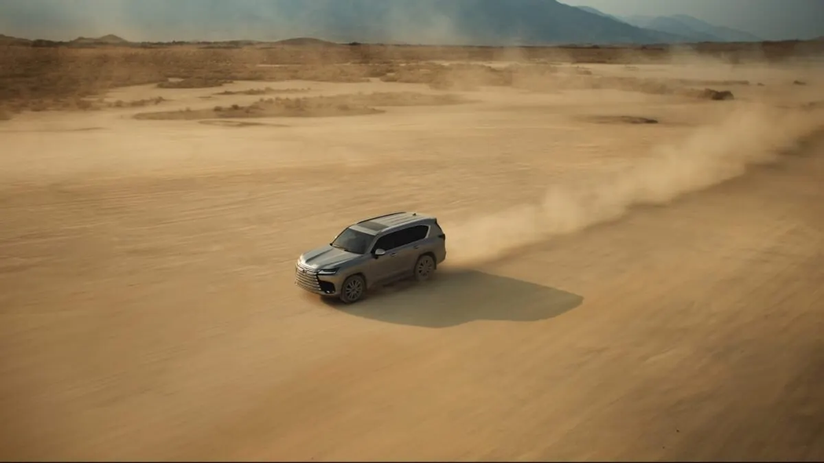 Lexus LX 600 kicking up dust across a desert flat