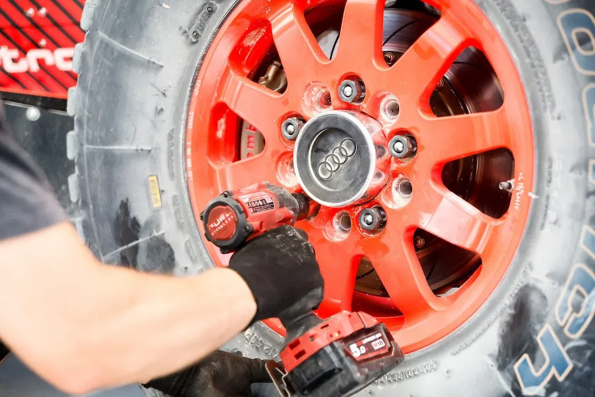 Mechanic using an impact wrench on an Audi RS Q e-tron wheel