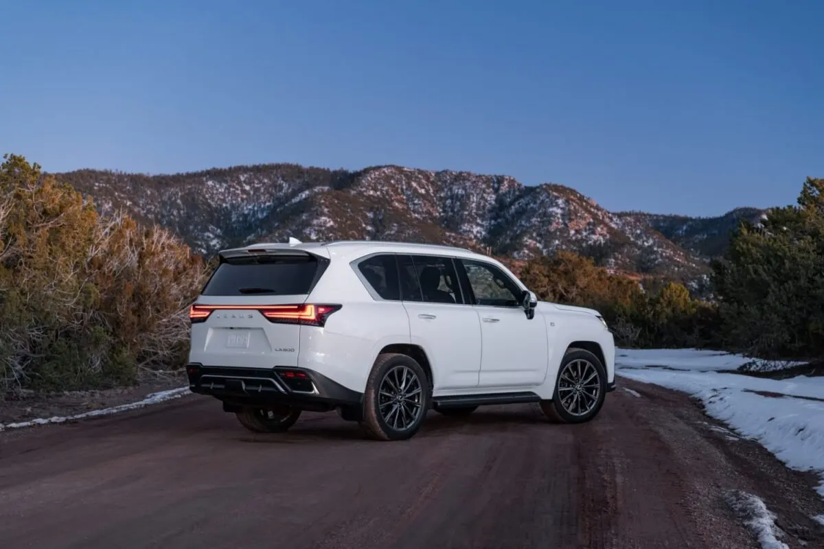 Rear view of a white Lexus LX 600 on a mountain road