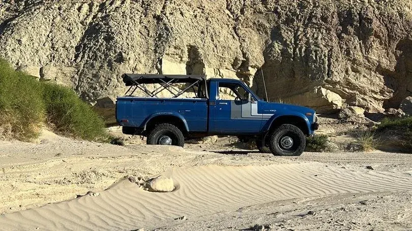 Retro Toyota pickup truck in the sand