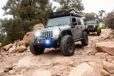 A line of Jeep Wanglers rock crawling