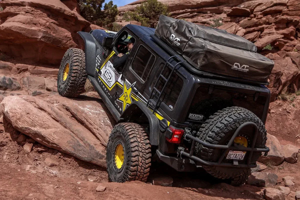 Black Jeep Wrangler JL climbing red slickrock