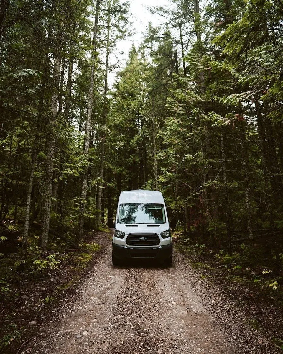 White camper van on a forest road