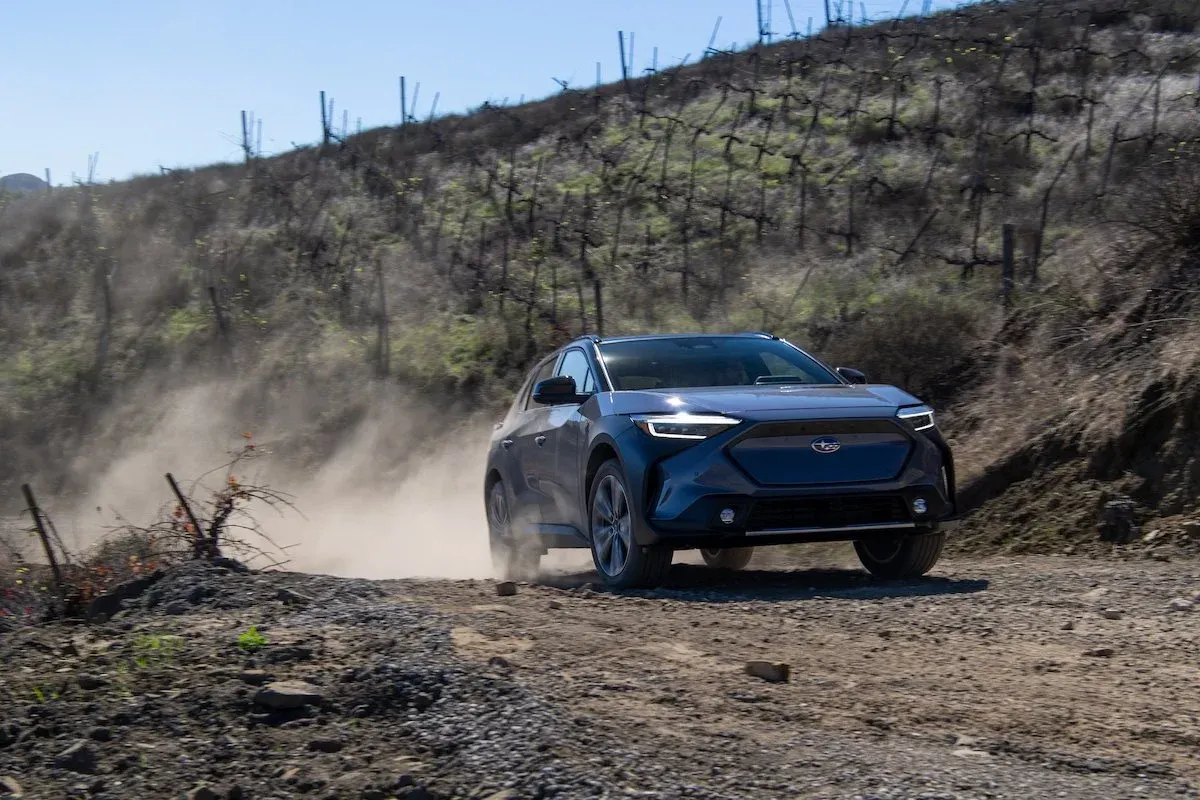 Subaru Solterra electric suv on a dirt trail driving fast